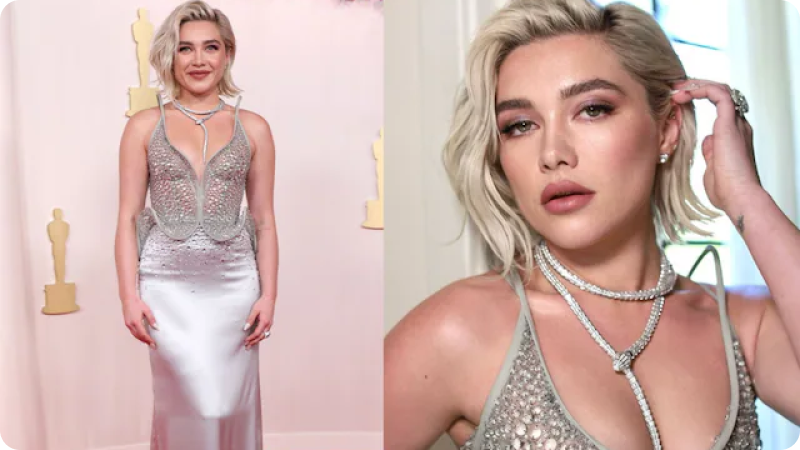 Florence Pugh wearing a shimmering silver gown with intricate detailing and a statement necklace, posing at an event or awards ceremony with Oscar statuettes in the background.
