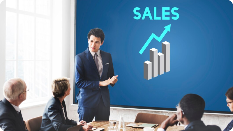 A man presenting and Sales is displayed