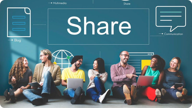 A group of diverse individuals sitting in a row, each with a laptop or tablet, in front of a wall displaying the word 'Share' and various icons representing blogging, multimedia, and communication, symbolizing collaboration and content sharing.